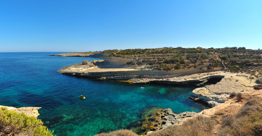 A beautiful photo of St Peter's showing a diving spot and clear blue water with the valley backdrop.